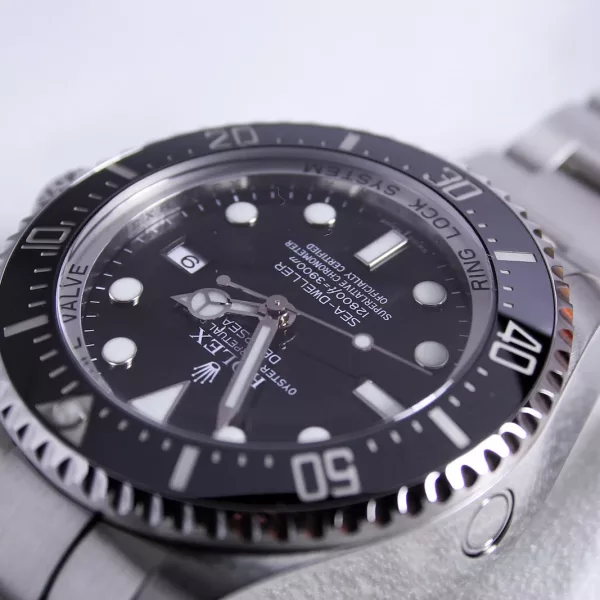 silver-colored Rolex analog watch reading at 1:55