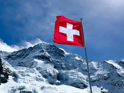 red flag on top of snow covered mountain